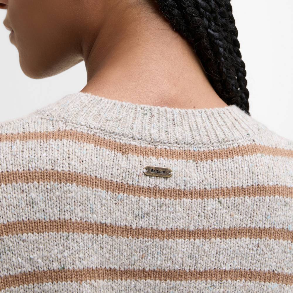 Close-up of a striped jumper with a brand label
