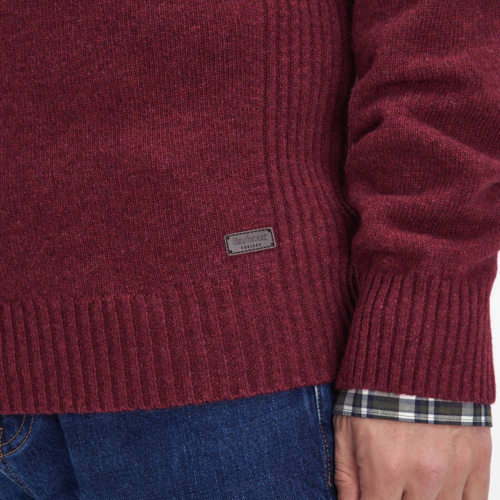 Close-up of a maroon sweater with a Barbour brand label