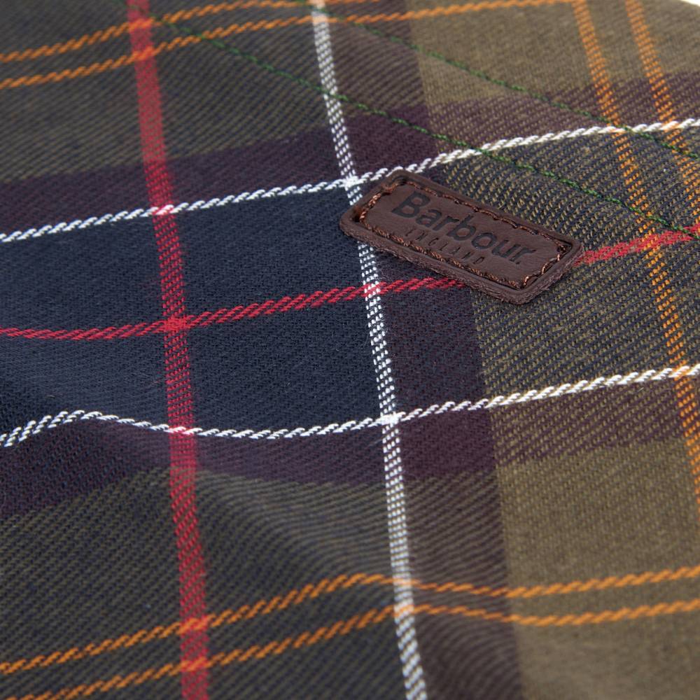 Close-up of a plaid fabric with a Barbour label